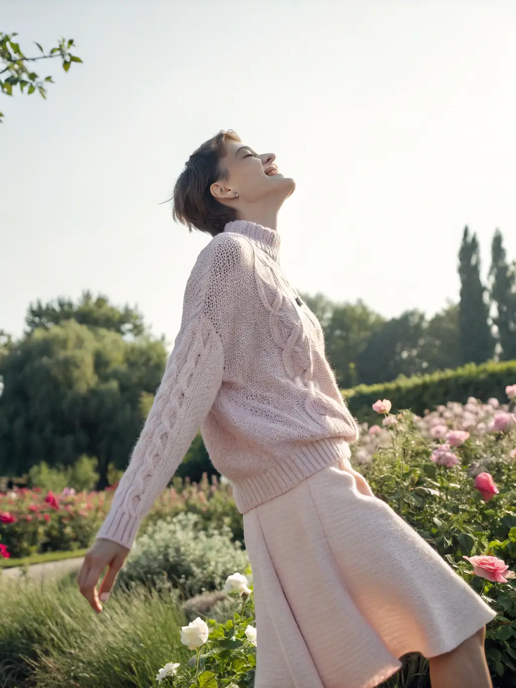A woman wearing a monochromatic outfit in pastel colors, featuring a sweater and skirt combination, standing against a soft, pastel-colored wall, emphasizing the subtle and trendy look.